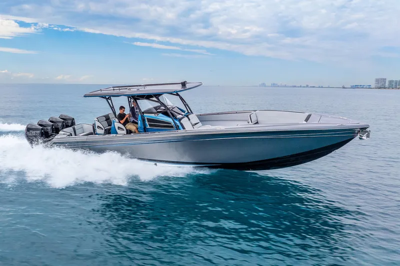Slide: The Image of 2024 Nor-Tech 390 Sport Center Console cruising on open water, showcasing sleek design and powerful engines. - 22