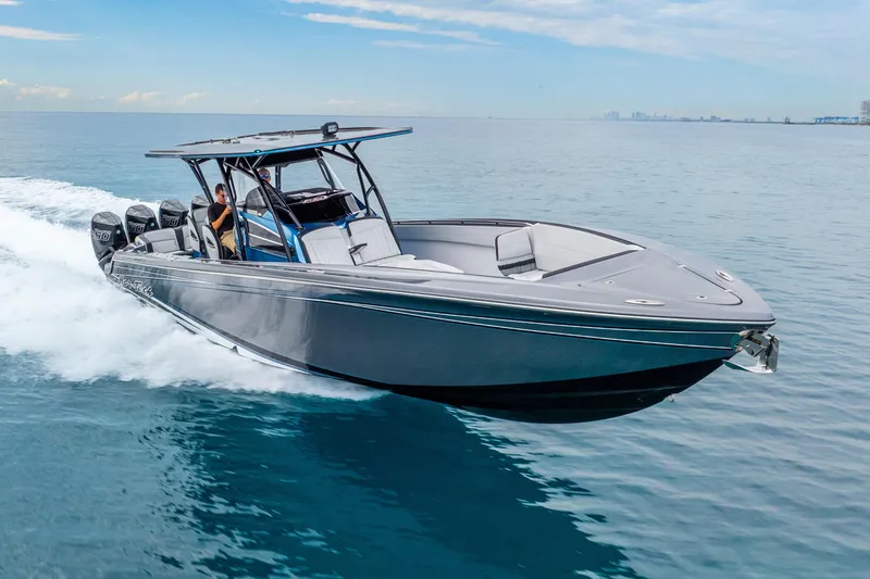 Slide: The Image of 2024 Nor-Tech 390 Sport Center Console cruising on open water, showcasing sleek design and powerful engines. - 23