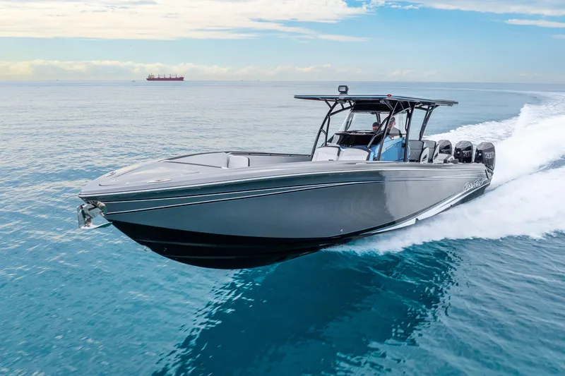 Slide: The Image of 2024 Nor-Tech 390 Sport Center Console cruising on open water, showcasing sleek design and powerful engines. - 24