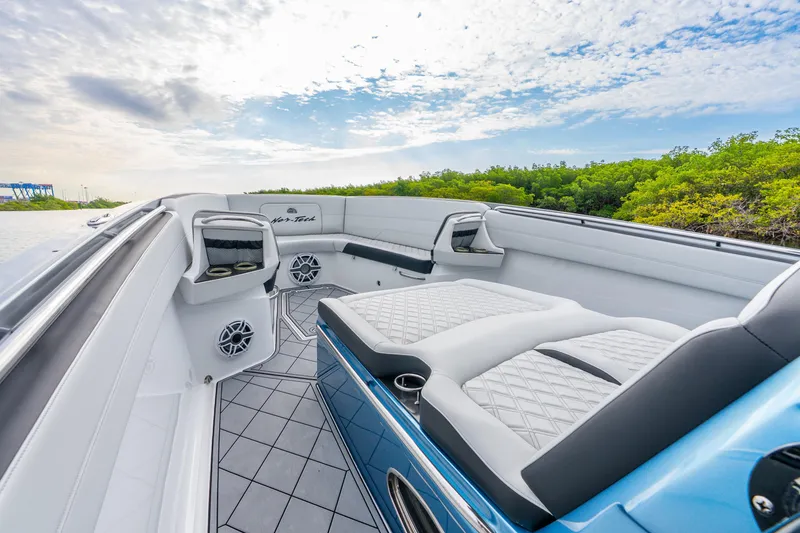 Slide: The Image of 2024 Nor-Tech 390 Sport Center Console boat interior with luxurious seating and modern design. - 30