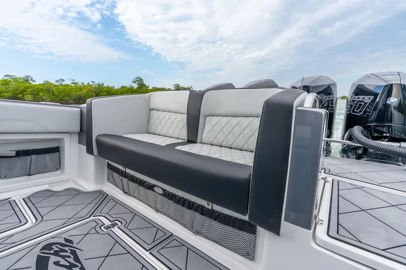 Slide: The Image of 2024 Nor-Tech 390 Sport Center Console with luxurious seating and powerful outboard engines. - 38
