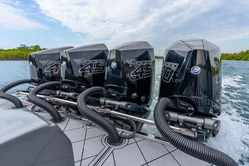 Slide: The Image of Four powerful outboard engines on a 2024 Nor-Tech 390 Sport Center Console boat. - 39