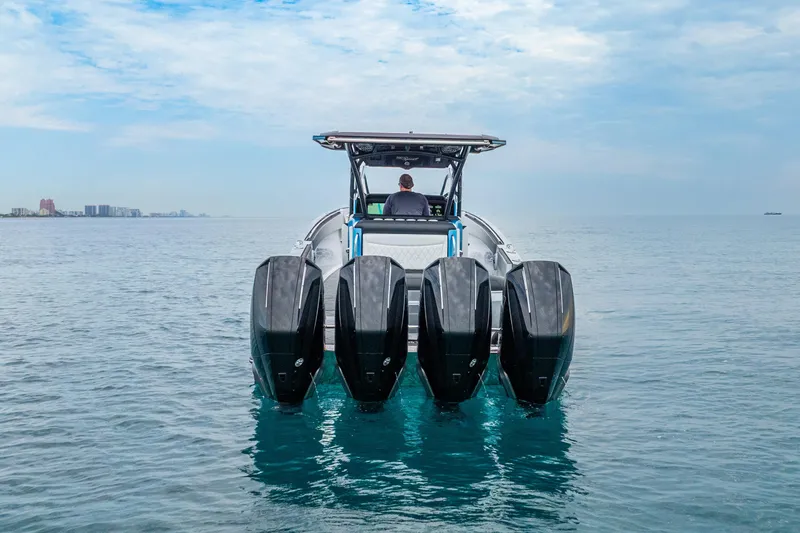 Slide: The Image of 2024 Nor-Tech 390 Sport Center Console with four powerful outboard engines on open water. - 4