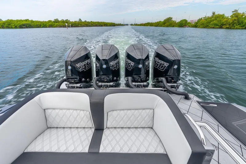 Slide: The Image of 2024 Nor-Tech 390 Sport Center Console with quad engines on open water. - 41