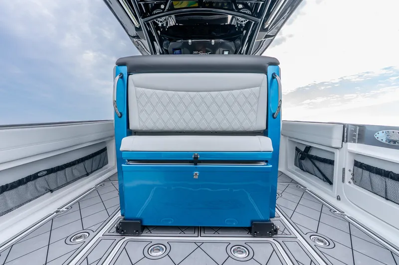 Slide: The Image of 2024 Nor-Tech 390 Sport Center Console interior with blue and white seating, modern design. - 43