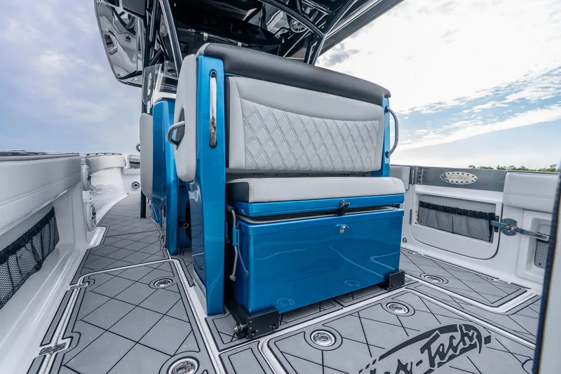 Slide: The Image of 2024 Nor-Tech 390 Sport Center Console interior with blue and white seating, sleek design. - 44