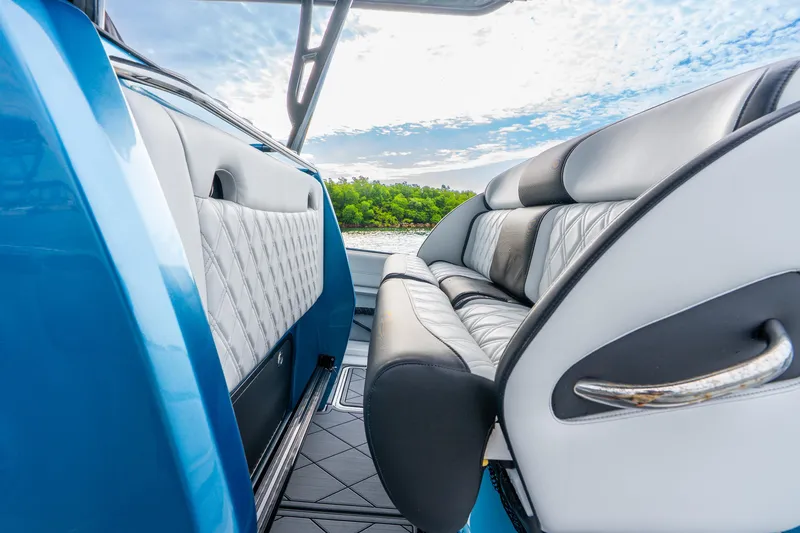 Slide: The Image of 2024 Nor-Tech 390 Sport Center Console interior with luxurious seating and scenic water view. - 46