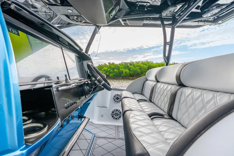 Slide: The Image of 2024 Nor-Tech 390 Sport Center Console interior with luxurious seating and modern dashboard. - 48