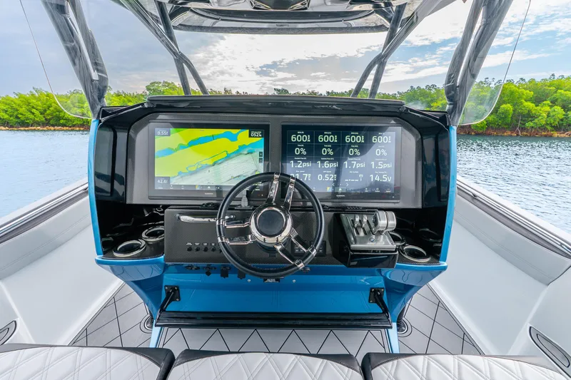 Slide: The Image of 2024 Nor-Tech 390 Sport Center Console dashboard with advanced navigation displays. - 49