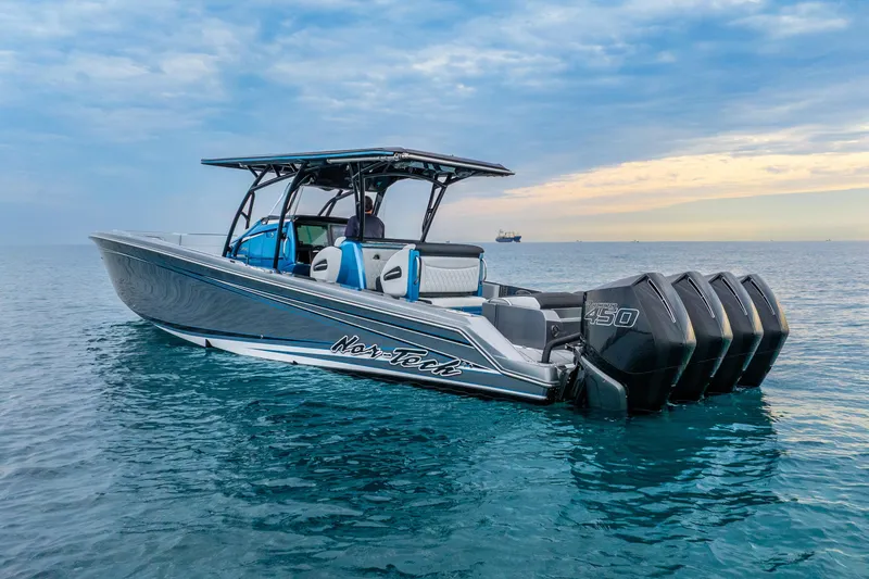 Slide: The Image of 2024 Nor-Tech 390 Sport Center Console boat on calm ocean waters. - 5