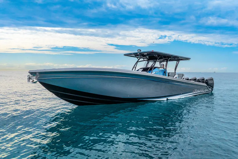 Slide: The Image of 2024 Nor-Tech 390 Sport Center Console boat on calm ocean waters under blue sky. - 7