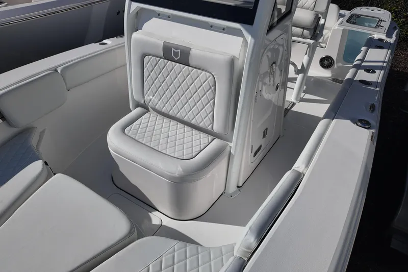 Slide: The Image of 2026 Sea Fox 228 Commander boat interior with white cushioned seating and console. - 10