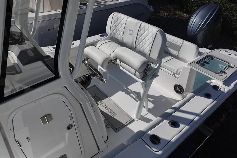 Slide: The Image of 2026 Sea Fox 228 Commander boat interior with white seating and console. - 11