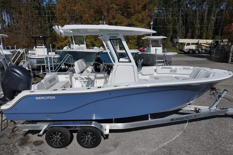 Slide: The Image of 2026 Sea Fox 228 Commander boat on trailer, parked outdoors. - 2