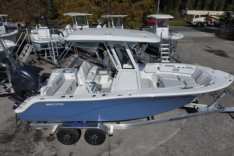 Slide: The Image of 2026 Sea Fox 228 Commander boat on trailer, featuring sleek design and spacious seating. - 3