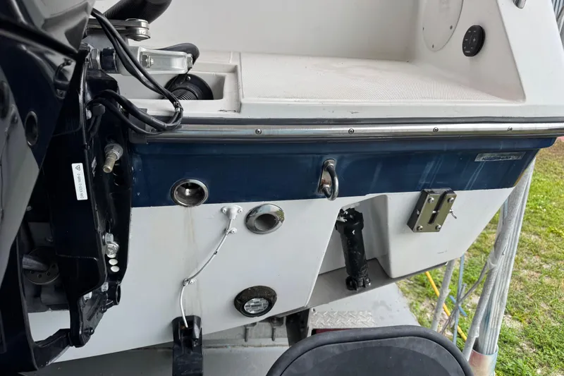 Slide: The Image of 2004 Stamas 290 Express boat stern with engine components and fittings visible. - 24