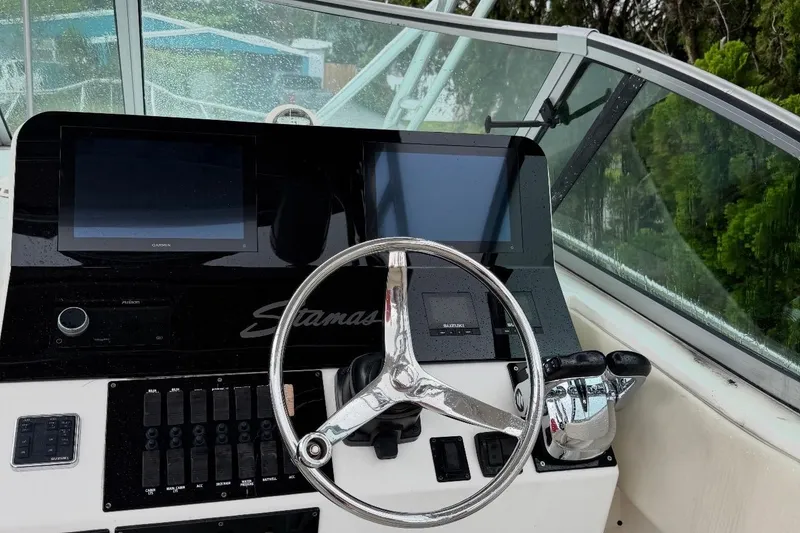 Slide: The Image of Helm of 2004 Stamas 290 Express boat with dual screens and steering wheel. - 3