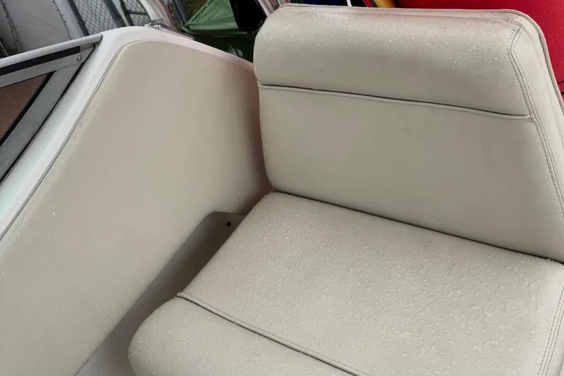Slide: The Image of Cream-colored seating on a 2004 Stamas 290 Express boat, slightly wet. - 4