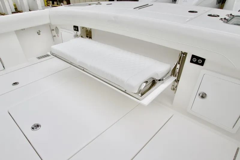 Slide: The Image of 2026 Regulator 37 boat with fold-out seating and sleek white interior design. - 10