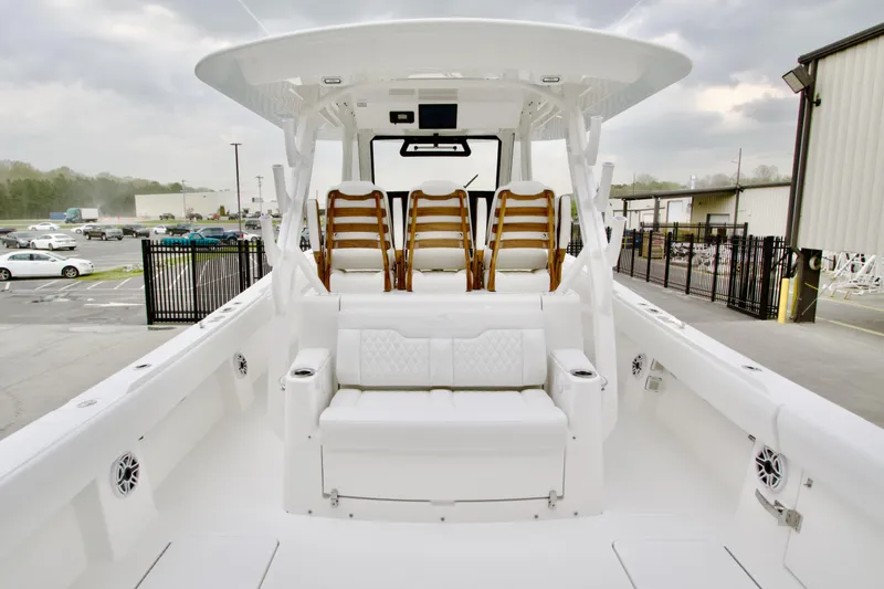 Slide: The Image of 2026 Regulator 37 boat interior with white seating and wooden accents. - 16