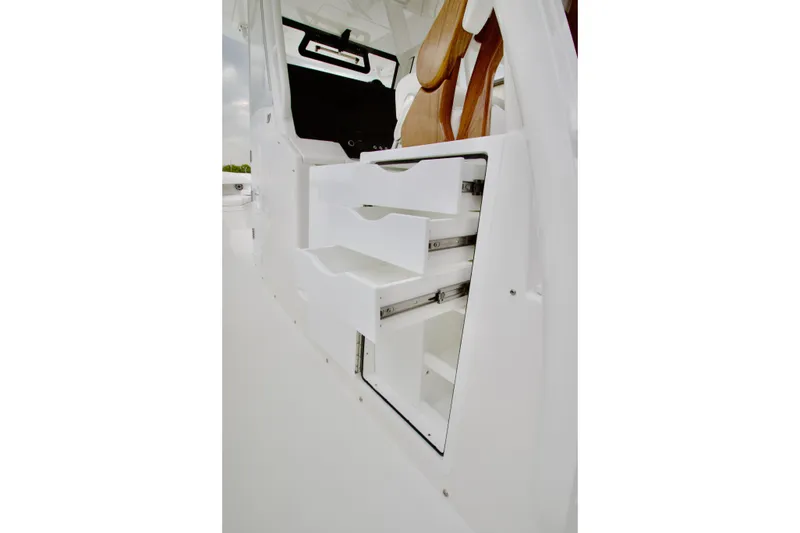 Slide: The Image of Interior storage drawers on 2026 Regulator 37 boat, featuring sleek white design. - 21