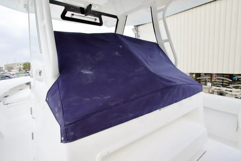 Slide: The Image of 2026 Regulator 37 boat with a blue protective cover on the console. - 22