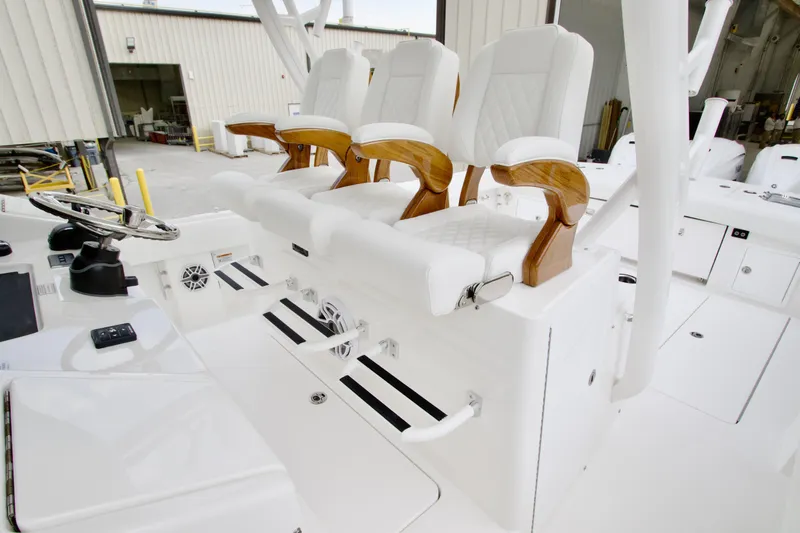 Slide: The Image of 2026 Regulator 37 boat helm with luxurious white seating and wooden accents. - 25