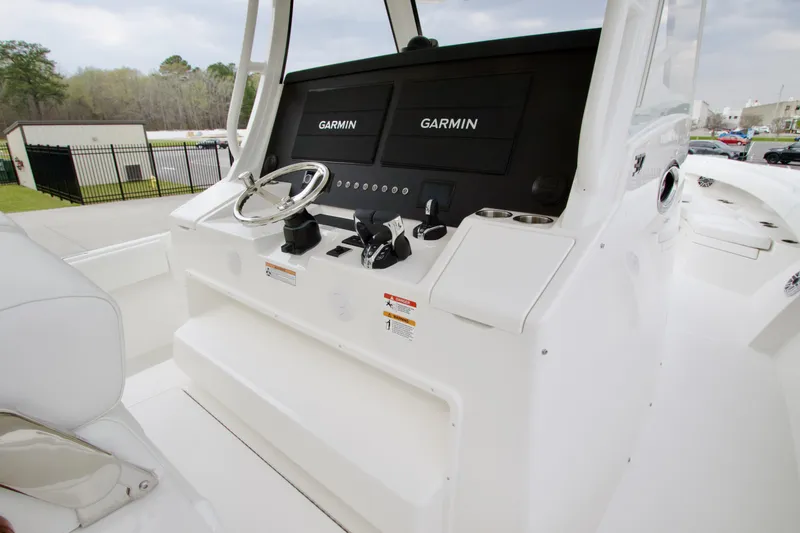 Slide: The Image of 2026 Regulator 37 boat helm with dual Garmin displays and steering wheel. - 27
