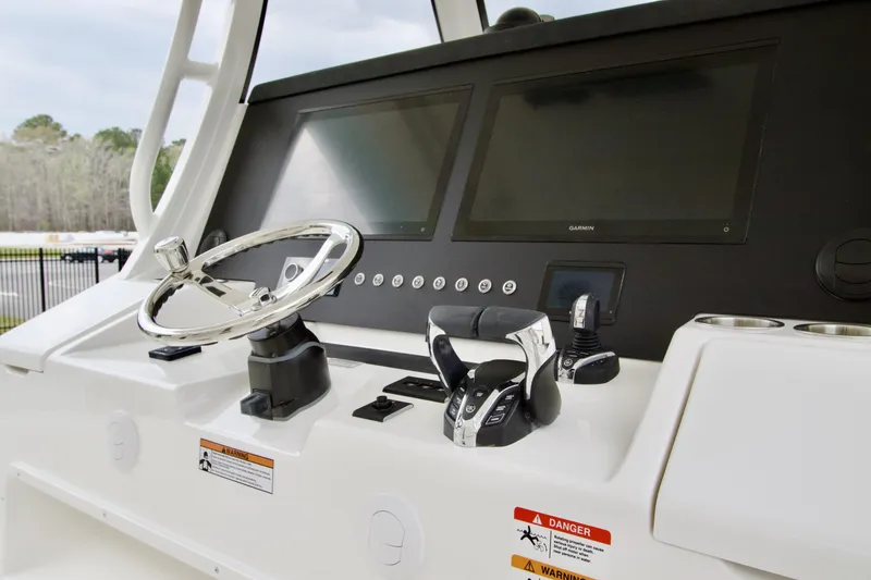 Slide: The Image of 2026 Regulator 37 boat helm with dual screens and controls. - 29