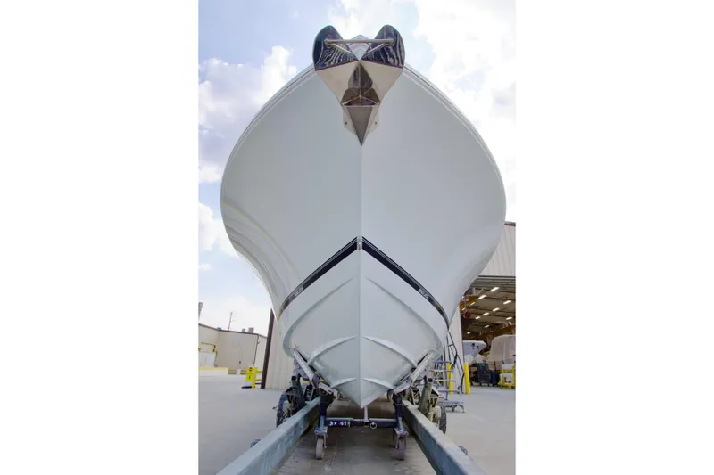 Slide: The Image of Front view of 2026 Regulator 37 boat in a shipyard setting. - 3
