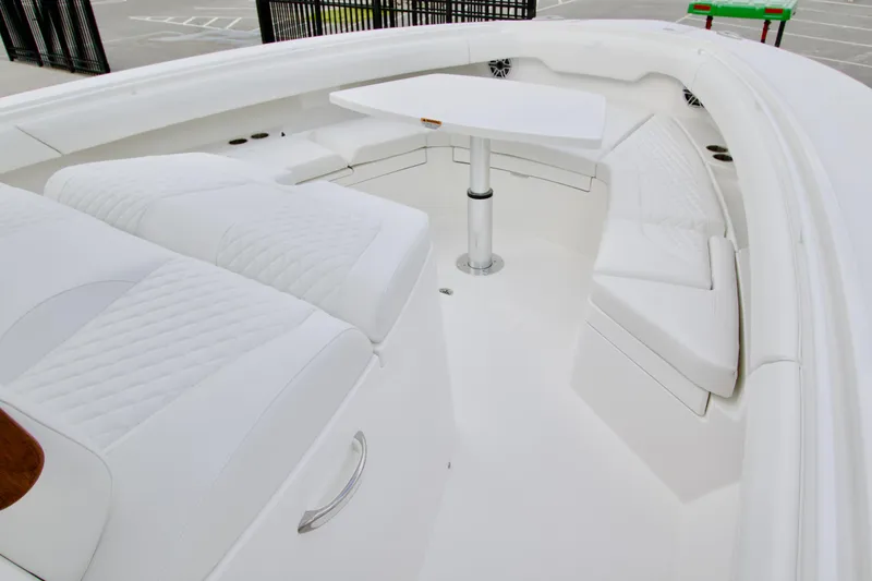 Slide: The Image of Luxurious seating area on a 2026 Regulator 37 boat with white upholstery and table. - 30