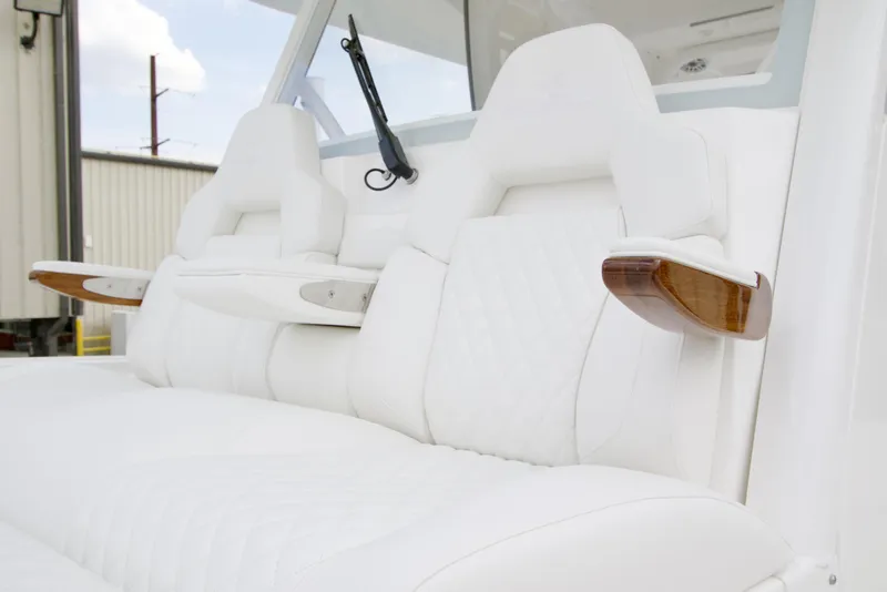Slide: The Image of Luxurious white seating on 2026 Regulator 37 boat with wooden armrests. - 34