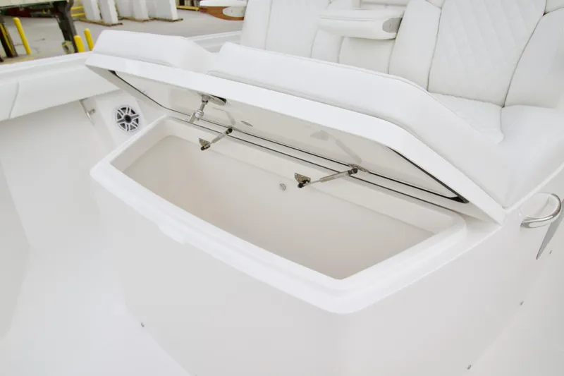 Slide: The Image of Open storage compartment on 2026 Regulator 37 boat with white seating. - 35