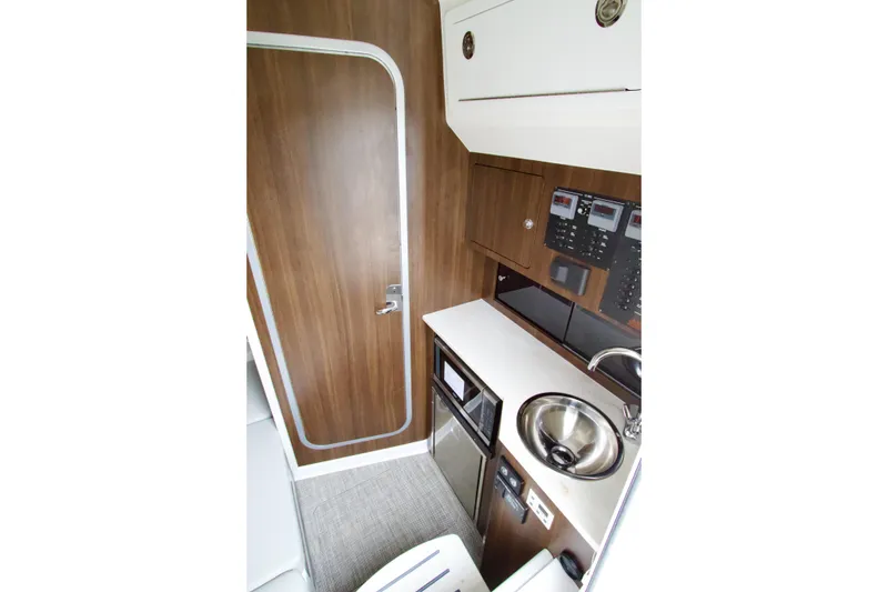 Slide: The Image of 2026 Regulator 37 boat interior with kitchenette, sink, and control panels. - 36