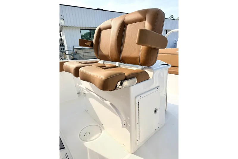 Slide: The Image of 2023 Sea Hunt Ultra 255 SE boat seating with brown cushions and white base. - 10