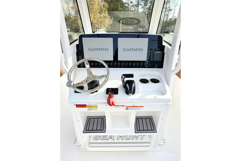 Slide: The Image of 2023 Sea Hunt Ultra 255 SE boat console with Garmin displays and steering wheel. - 14