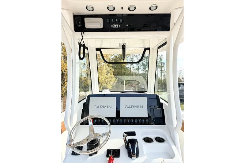 Slide: The Image of 2023 Sea Hunt Ultra 255 SE boat dashboard with Garmin navigation system and steering wheel. - 15