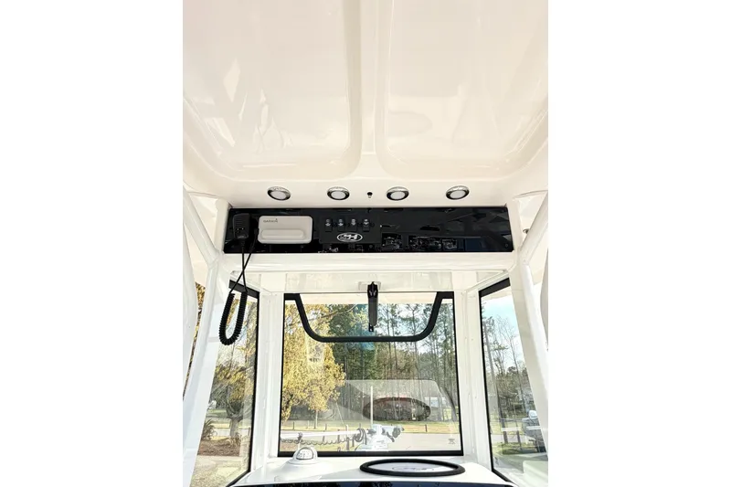Slide: The Image of 2023 Sea Hunt Ultra 255 SE boat console with navigation equipment and controls. - 16