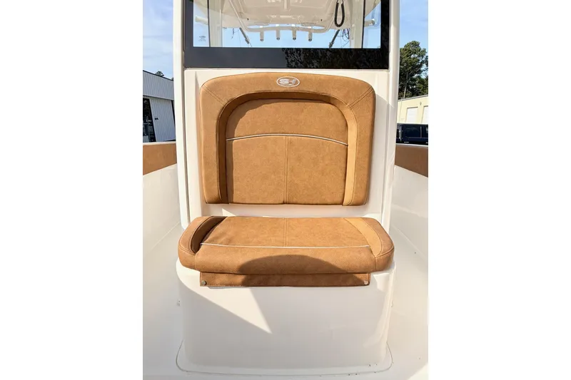 Slide: The Image of 2023 Sea Hunt Ultra 255 SE boat seat with tan upholstery and sleek design. - 19