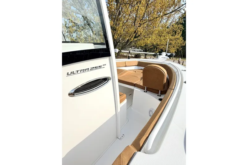 Slide: The Image of 2023 Sea Hunt Ultra 255 SE boat interior with tan seating and sleek design. - 21