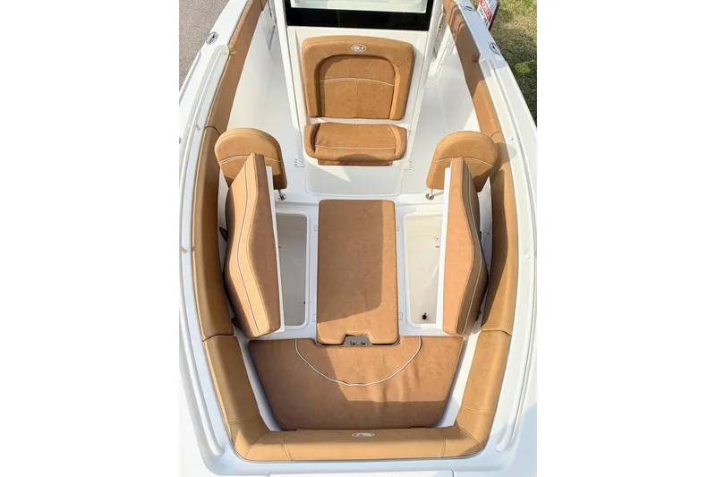 Slide: The Image of 2023 Sea Hunt Ultra 255 SE boat interior with tan cushioned seating. - 23
