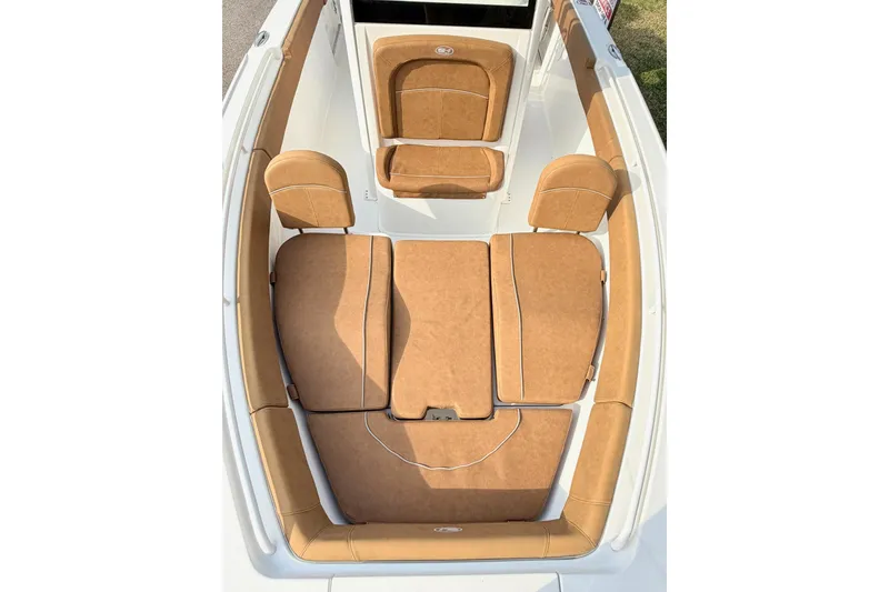 Slide: The Image of 2023 Sea Hunt Ultra 255 SE boat interior with tan cushioned seating. - 24