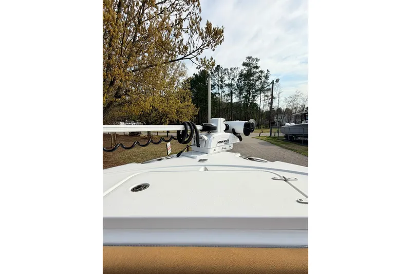 Slide: The Image of 2023 Sea Hunt Ultra 255 SE boat with Minn Kota trolling motor, parked outdoors. - 25