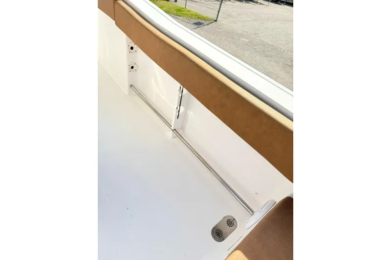 Slide: The Image of 2023 Sea Hunt Ultra 255 SE boat interior detail with brown upholstery and stainless steel railing. - 5