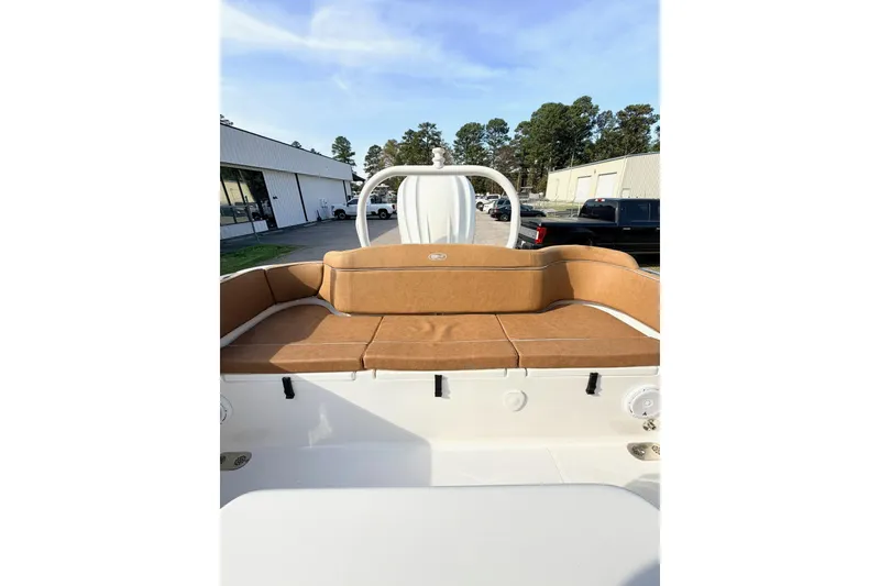 Slide: The Image of 2023 Sea Hunt Ultra 255 SE boat interior with tan seating and white deck. - 7