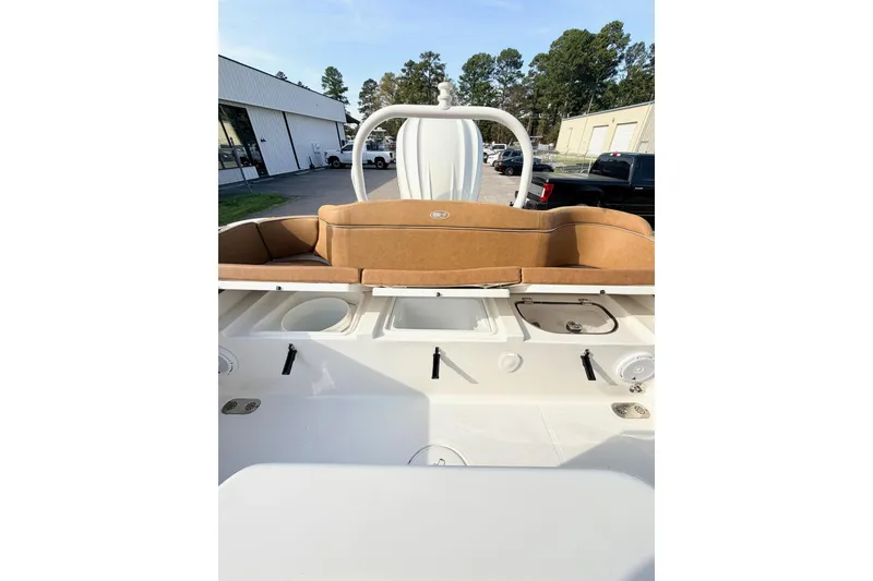 Slide: The Image of 2023 Sea Hunt Ultra 255 SE boat interior with tan seating and storage compartments. - 8