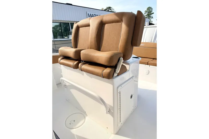 Slide: The Image of 2023 Sea Hunt Ultra 255 SE boat with tan cushioned seating. - 9