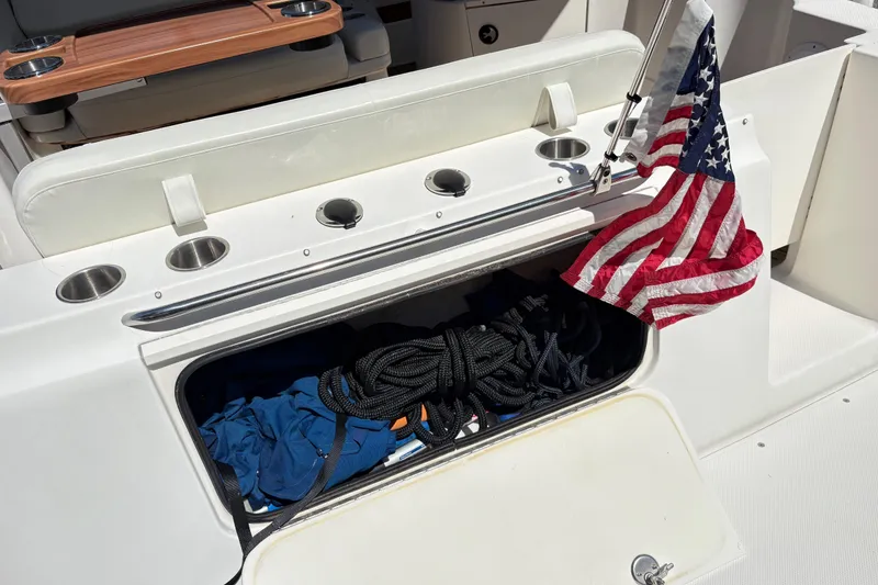 Slide: The Image of 2003 Bayliner 285 Ciera boat storage with American flag and ropes. - 10