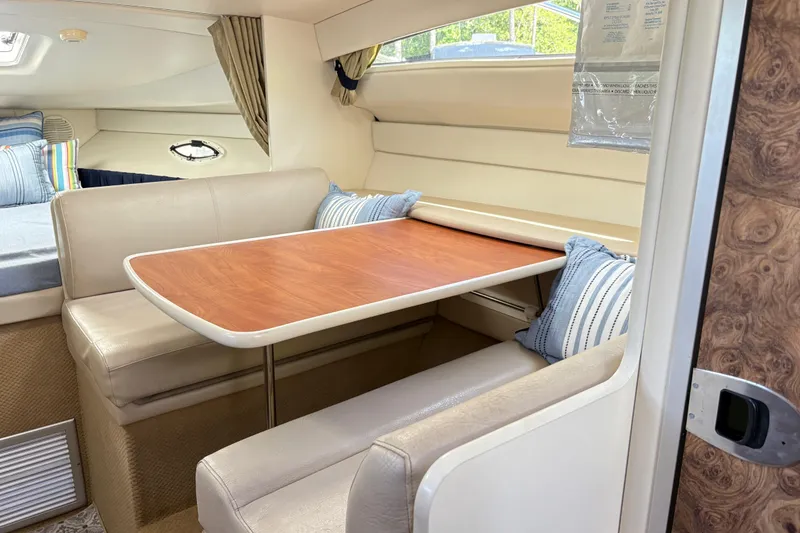 Slide: The Image of Interior of 2003 Bayliner 285 Ciera with dining area and cozy seating. - 11