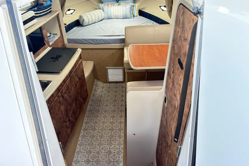 Slide: The Image of Interior of 2003 Bayliner 285 Ciera boat with cozy cabin and dining area. - 12